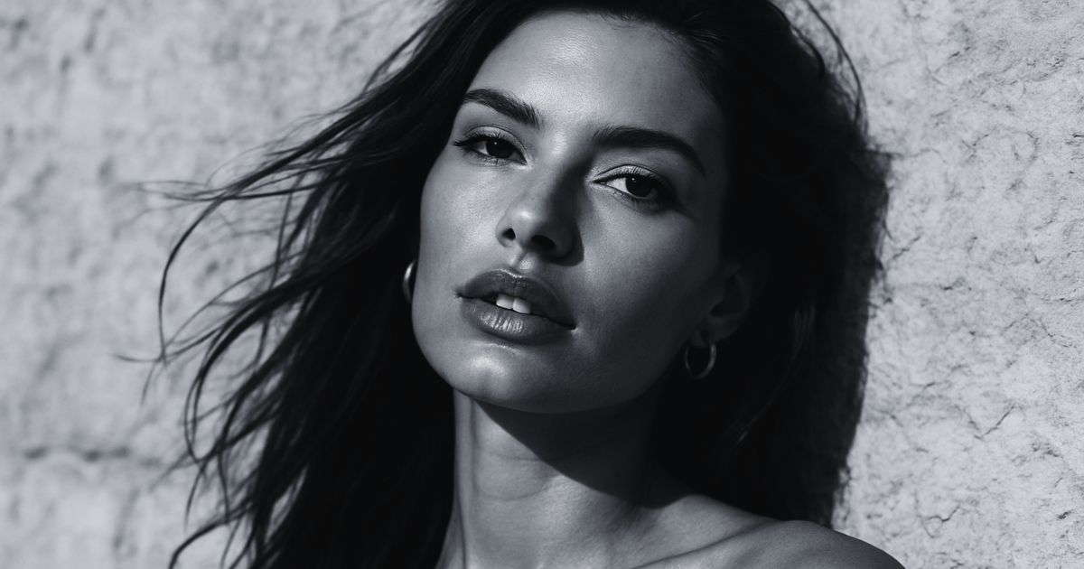 Blog 2 Black-and-white portrait of a woman with long dark hair.